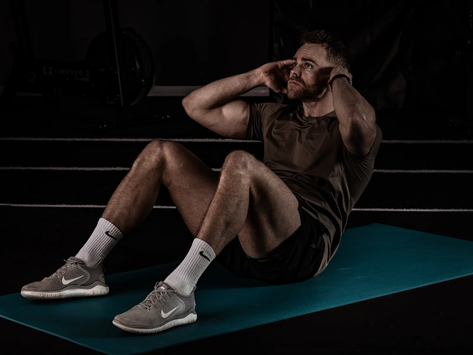 Athlete performing a core exercise on a Conquer training mat